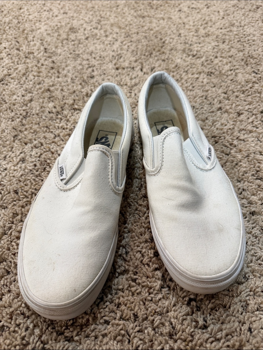 Vans women’s Slip-On Sneakers in White Canvas